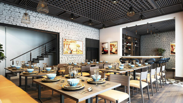 Un espace repas vide dans un hôtel. Les tables sont dressées.